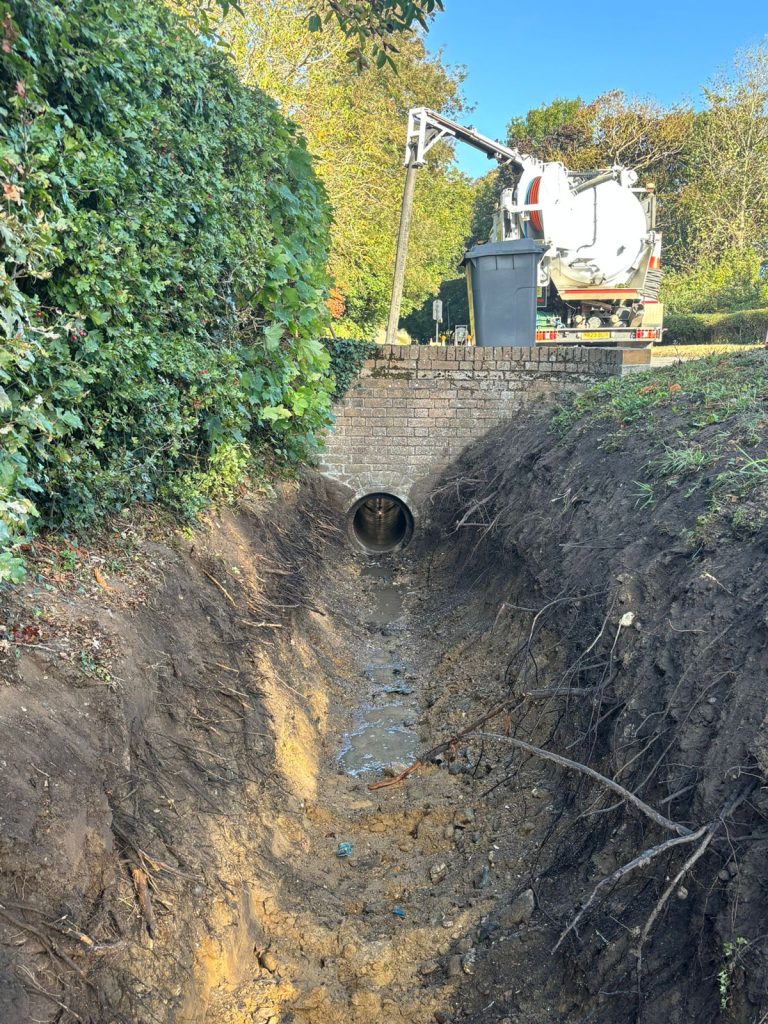 Commercial drain jetting equipment used to successfully clear a blocked outdoor culvert.