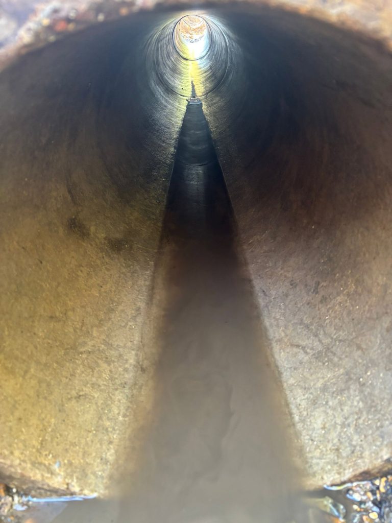 Internal view of a clean, clear underground drainage pipe after successful jetting